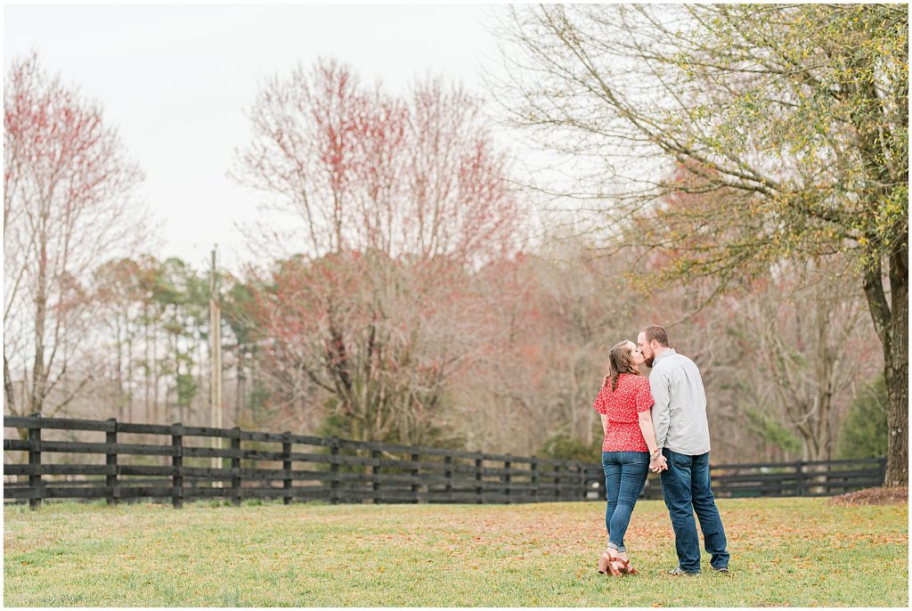 Richmond Spring Engagement Session at Wisteria Farms with trees and leaves in field