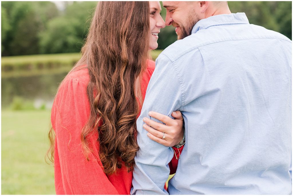 engagement session couple at edgewood barn holding arm with ring