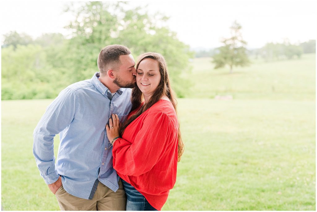 engagement session couple hugging each other at barn at edgewood