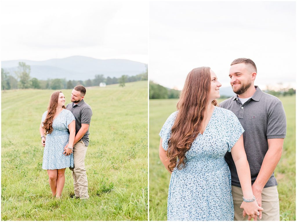 engagement session couple in blue and grey outfits standing in field at edgewood barn venue with mountain view