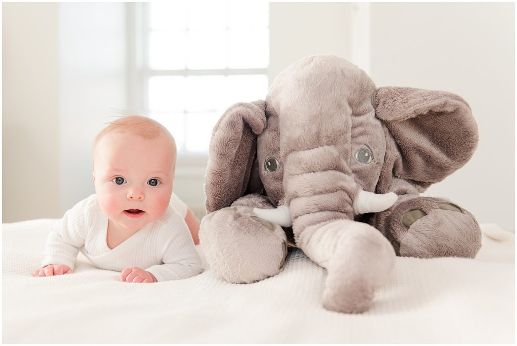 Richmond photographers niles lying on bed with elephant on stomach