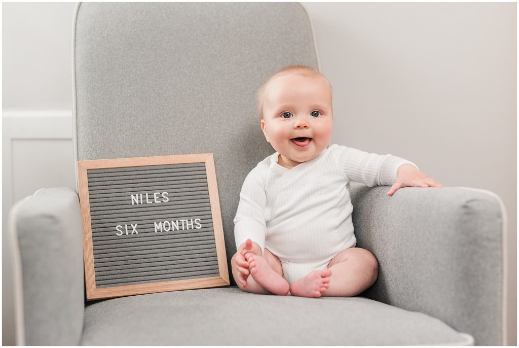 Richmond photographers niles turned 6 months sitting on chair with letter board