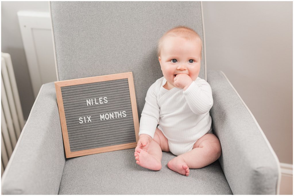 Richmond photographers niles turned 6 months sitting with letter board 