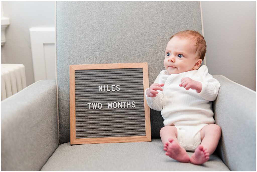 Richmond photographers niles sitting at 2 months with letter board
