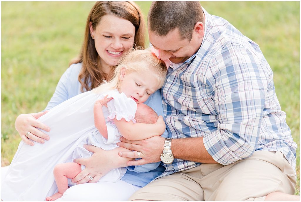 Backyard Newborn and Family Photography toddler hugging baby