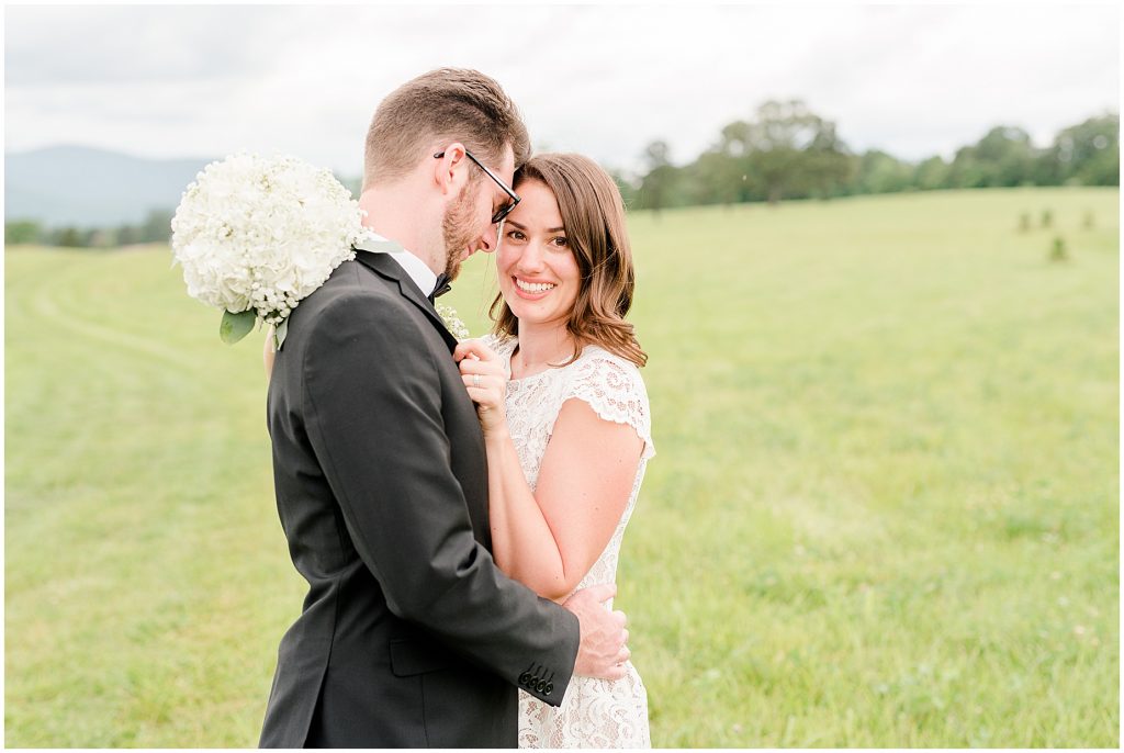 Bride and groom in open field at the barn at edgewood