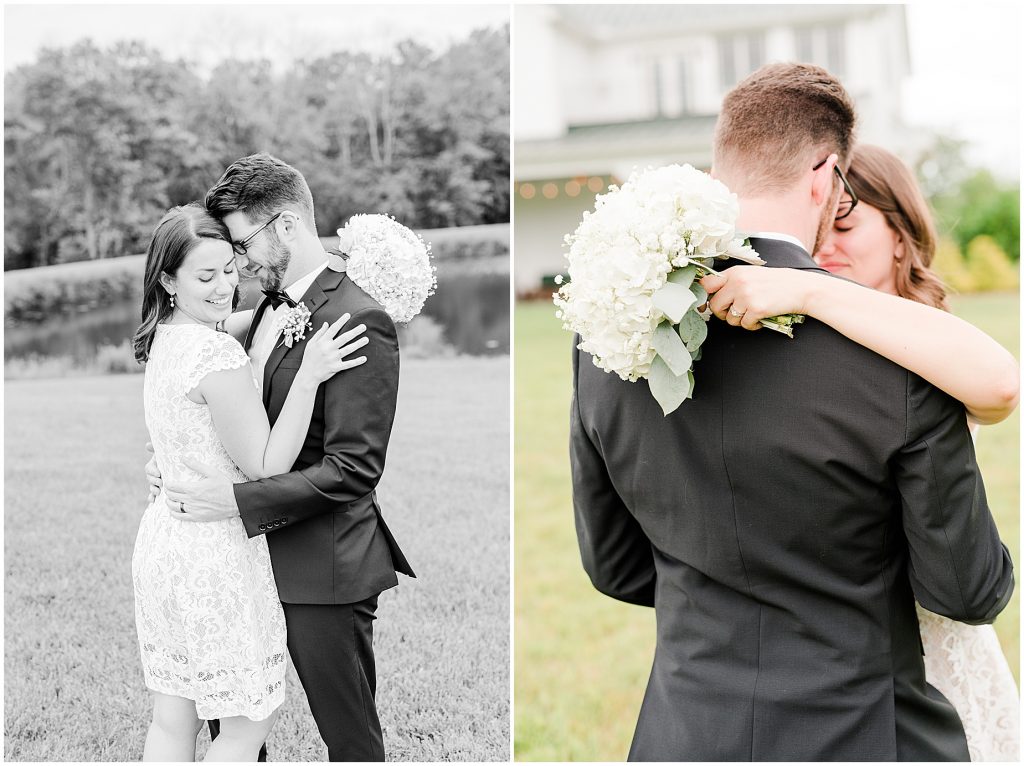 Bride and groom wrapped up together in front of lake at barn at edgewood after mini wedding