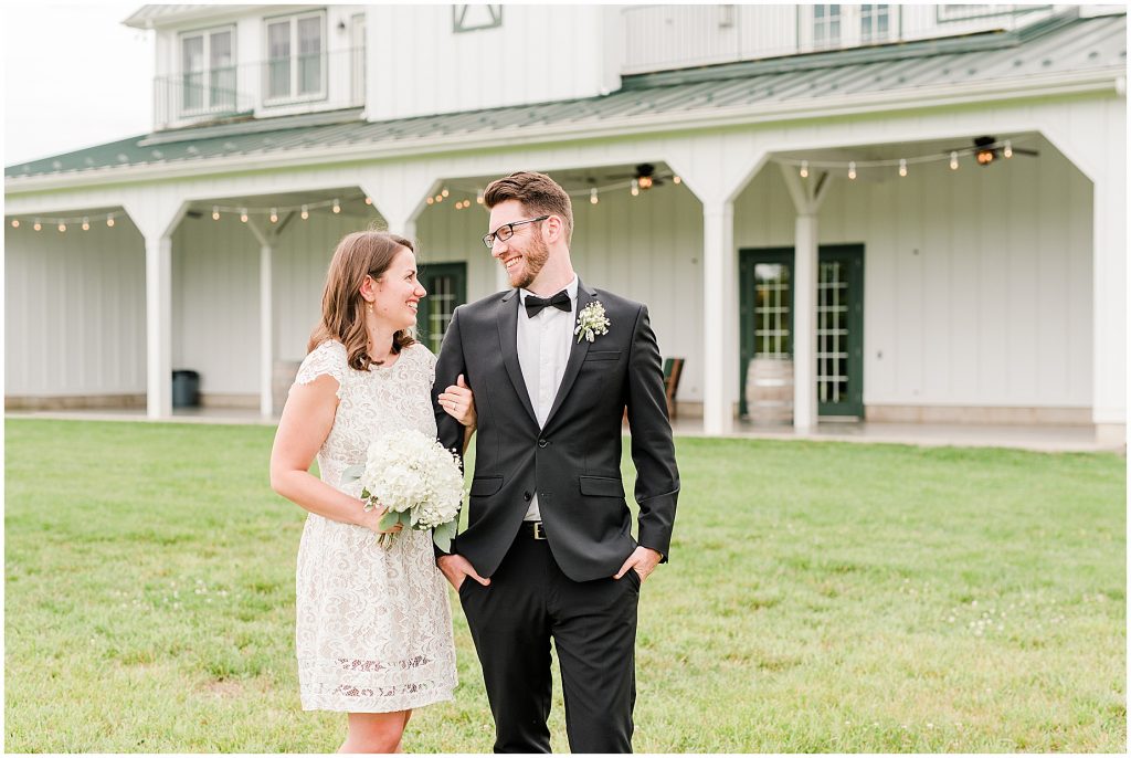 Bride and groom just married in front of barn at edgewood after coronavirus mini wedding