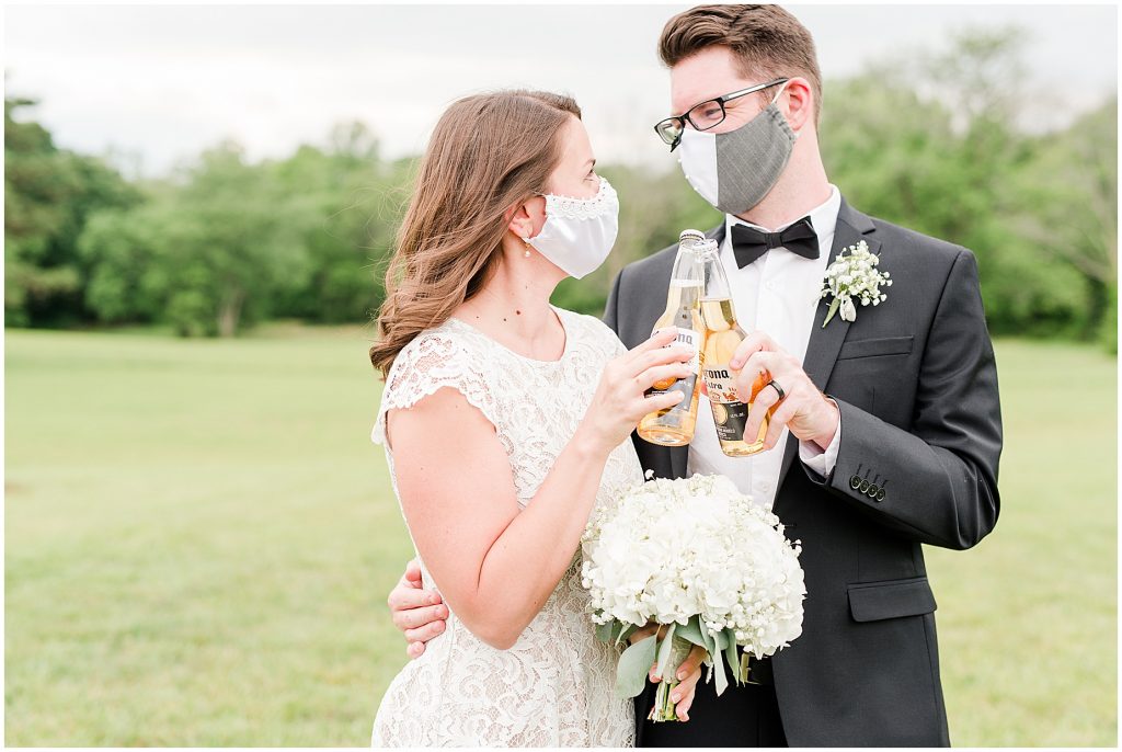 barn at edgewood coronavirus mini wedding couple with masks and cheering coronas