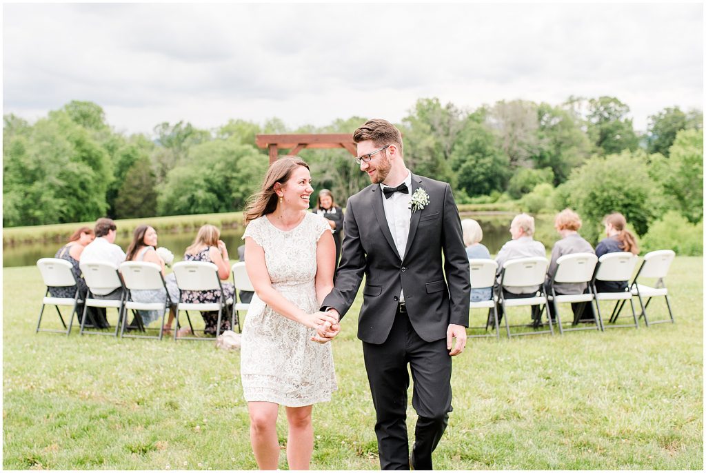 barn at edgewood coronavirus mini wedding bride and groom walking down aisle married