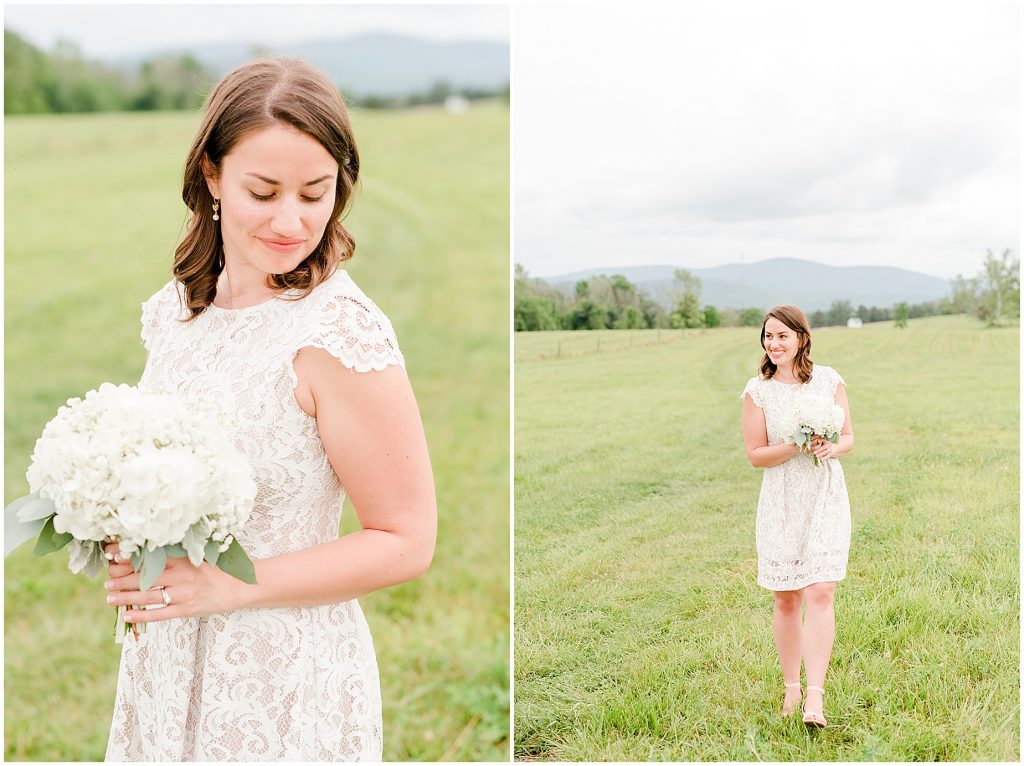 Bride holding bouquet in field at barn at edgewood