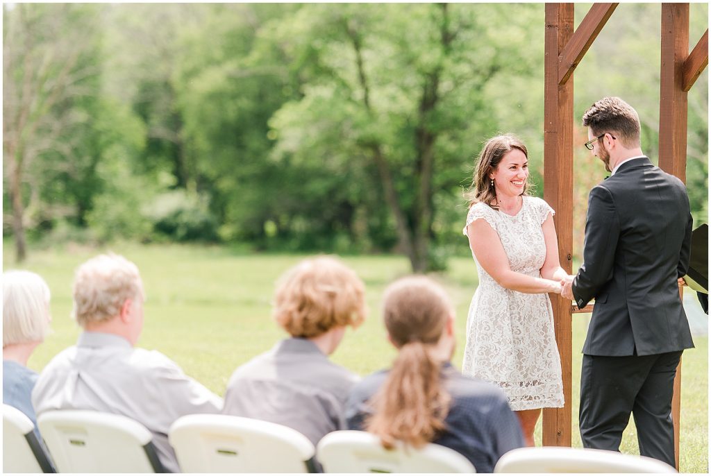barn at edgewood coronavirus mini wedding bride and groom holding hands at altar