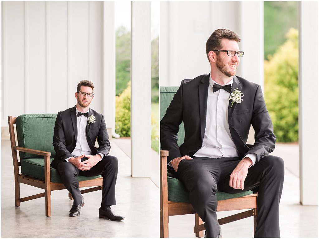 white barn at edgewood summer mini wedding groom in black suit sitting