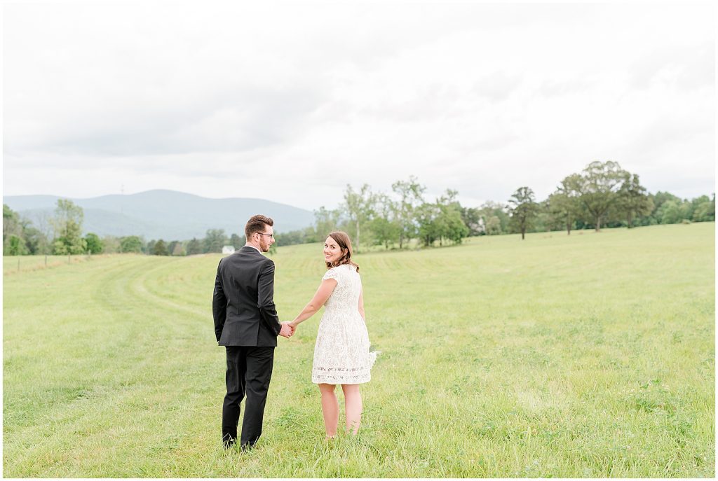 Bride and groom in open field at the barn at edgewood after mini wedding