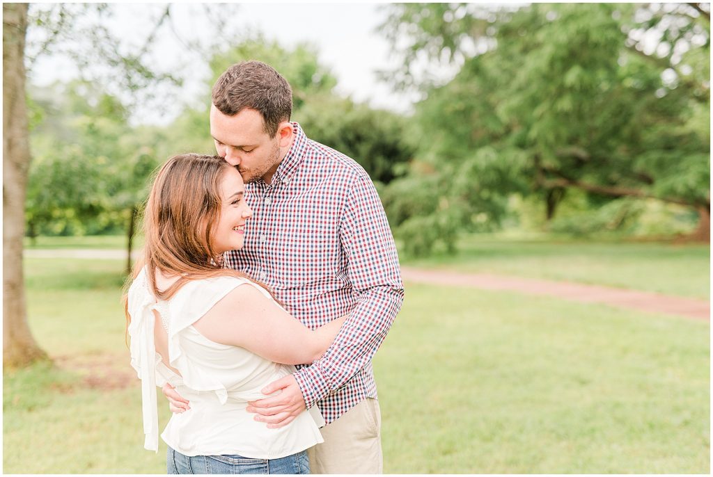 rainy maymont park engagement couple in clearing