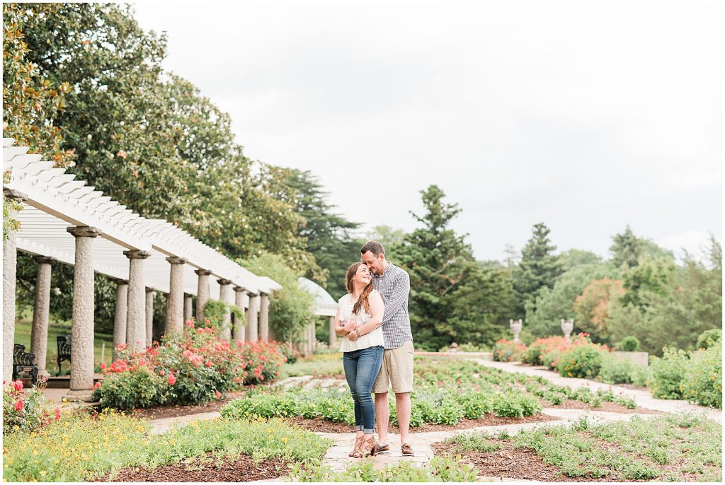 rainy engagement session couple at maymont park standing in italian flower garden