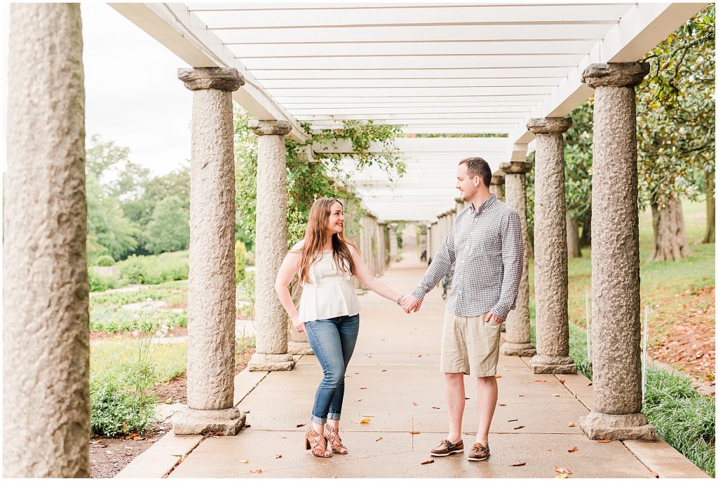 engagement session couple at maymont park standing under gazebo walkway