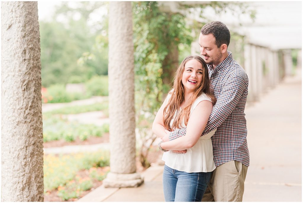 engagement session couple at maymont park standing under gazebo walkway after it rains