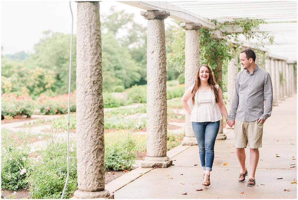 engagement session couple at maymont park walking under gazebo next to italian flower garden