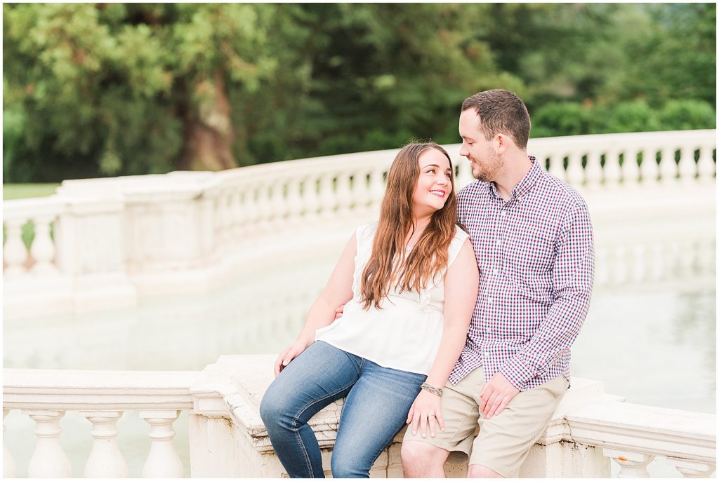 rainy engagement session couple at maymont park sitting at pearl fountain