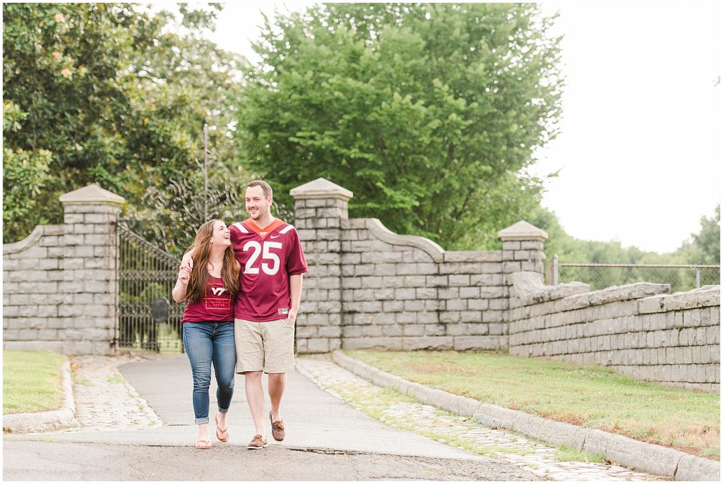 engagement session couple at maymont park gate and stone wall in virginia tech gear