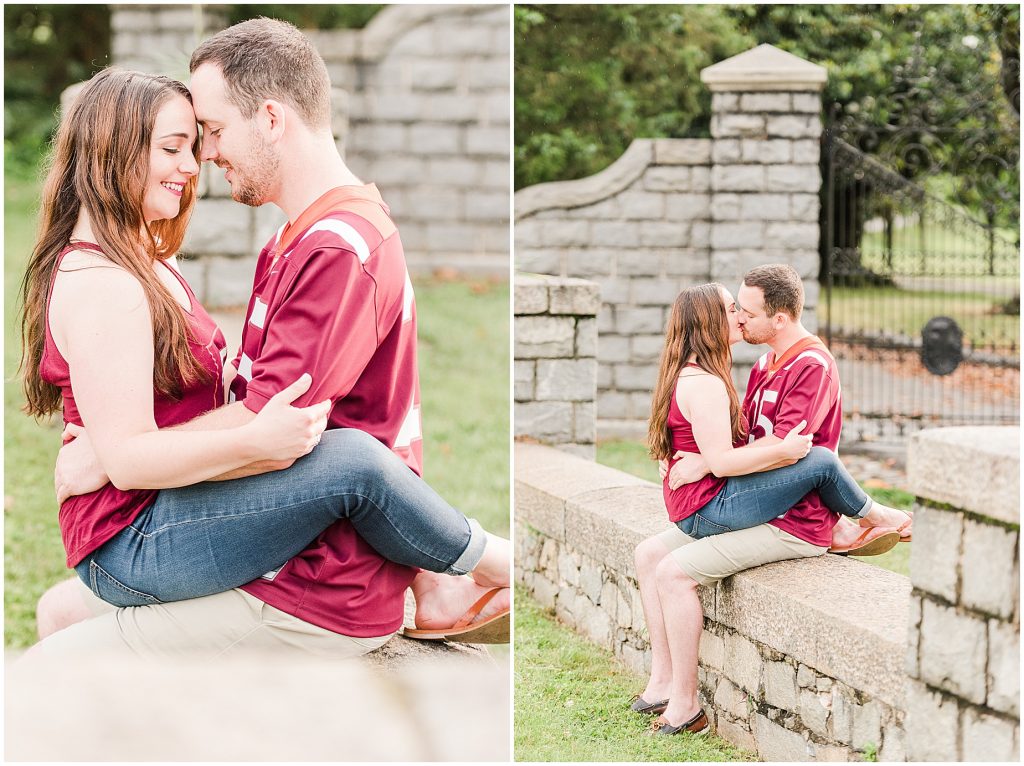 rainy engagement session couple sitting on each other in virginia tech shirts