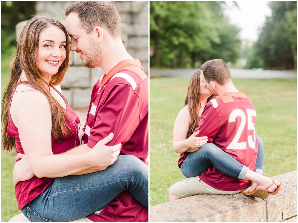 rainy engagement session couple sitting on each other in virginia tech shirts