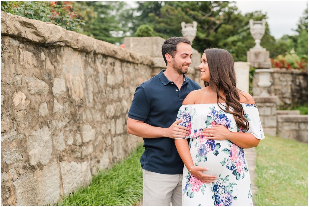 maymont maternity session with floral dress near rock wall in Richmond Virginia