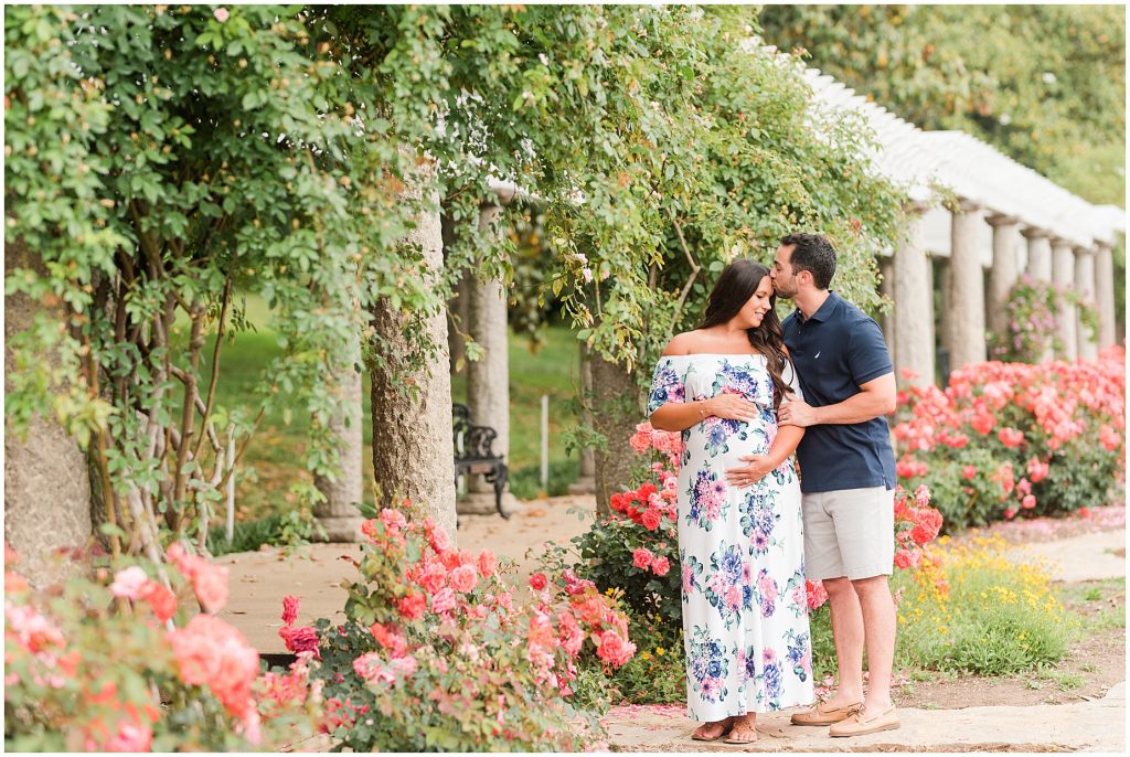maymont park maternity husband and wife kissing in flower garden in Richmond Virginia