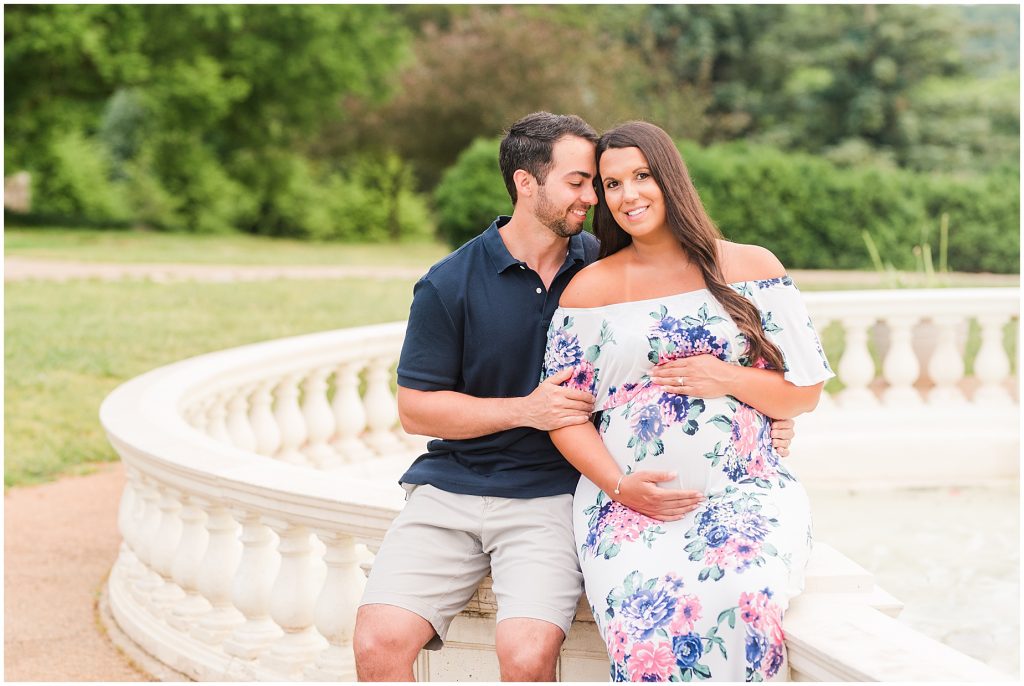 maymont park husband and pregnant wife sitting on stone rail in Richmond Virginia