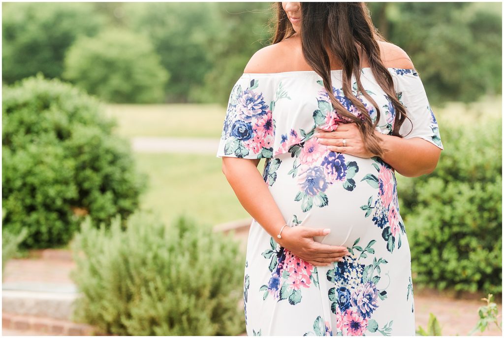 maymont park maternity woman holding stomach in garden in Richmond Virginia