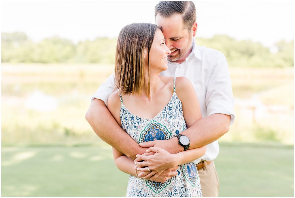 sunny Lansdowne resort engagement session couple on golf course in Leesburg, VA
