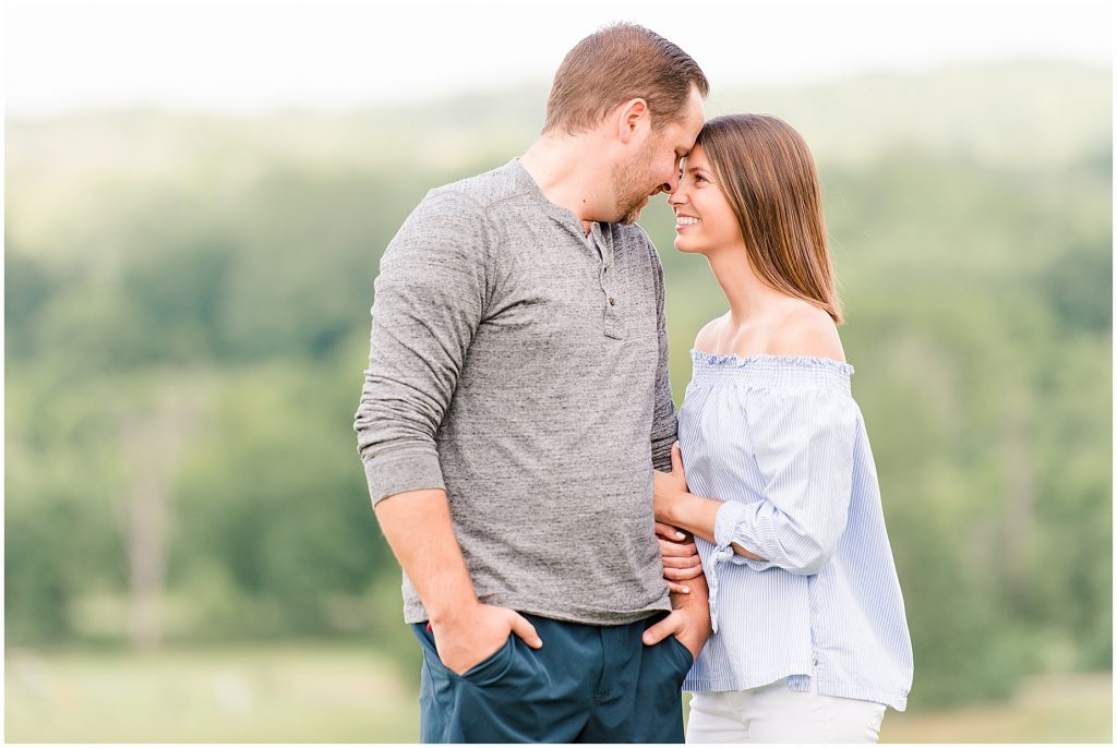 Lansdowne golf resort engagement couple in blue and grey outfits standing on overlook