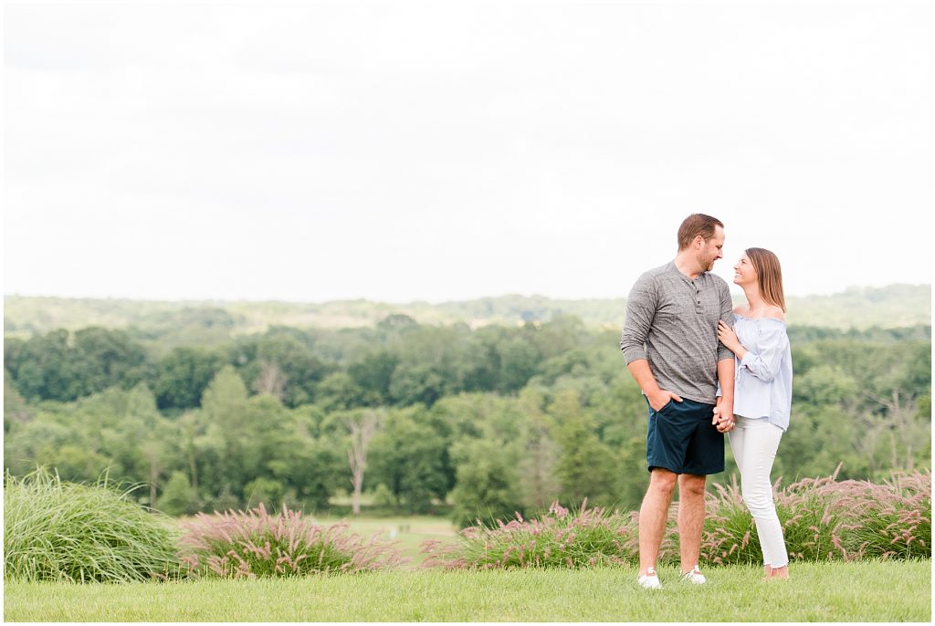 Lansdowne golf resort engagement couple in blue and grey outfits standing at an overlook