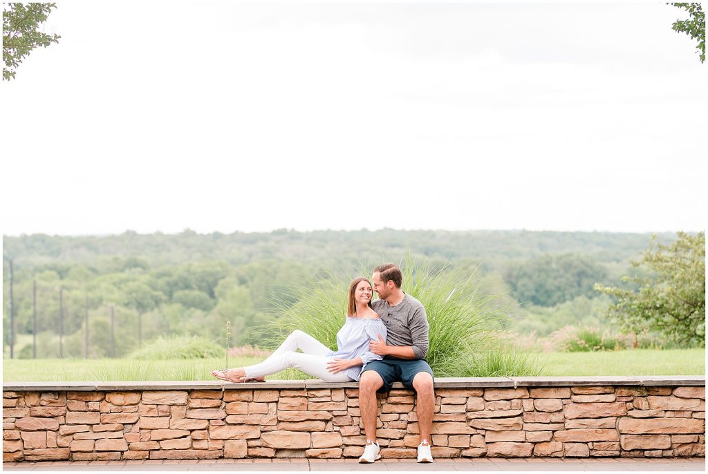 Lansdowne golf resort engagement couple sitting on stone wall
