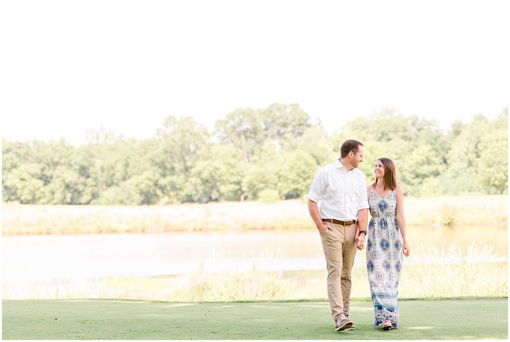 sunny Lansdowne resort engagement session couple on golf course in Leesburg, VA