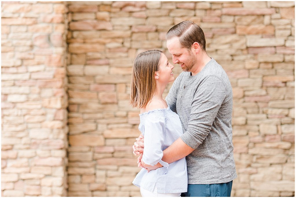 Lansdowne golf resort engagement couple in front of stone wall