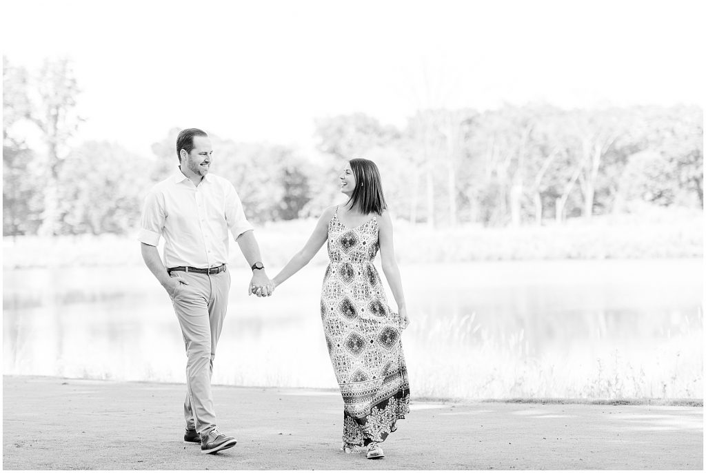 sunny summer Lansdowne resort engagement session couple on golf course in Leesburg, VA