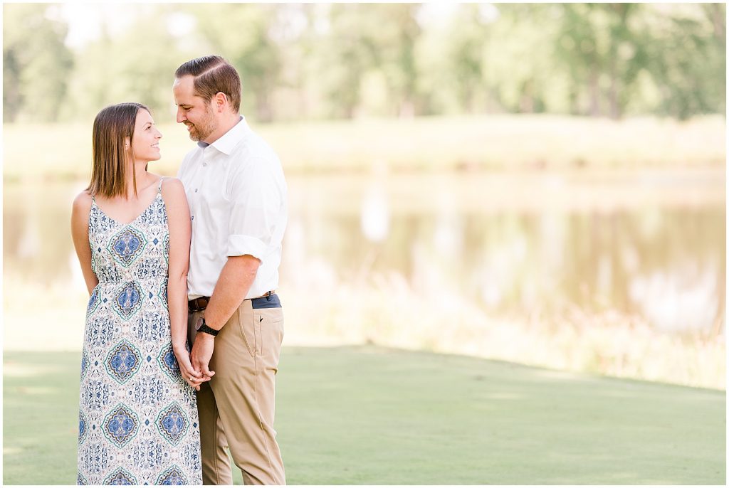sunny Lansdowne resort engagement session couple on golf course in Leesburg, VA