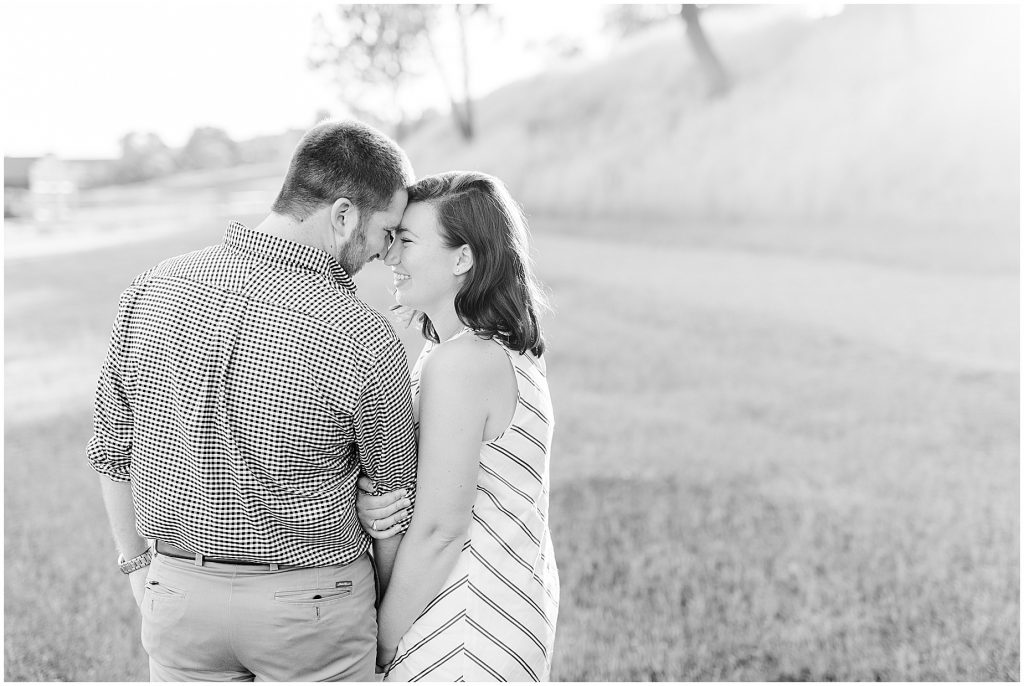 richmond engagement couple on hill near browns island with glowy sun behind in black and white