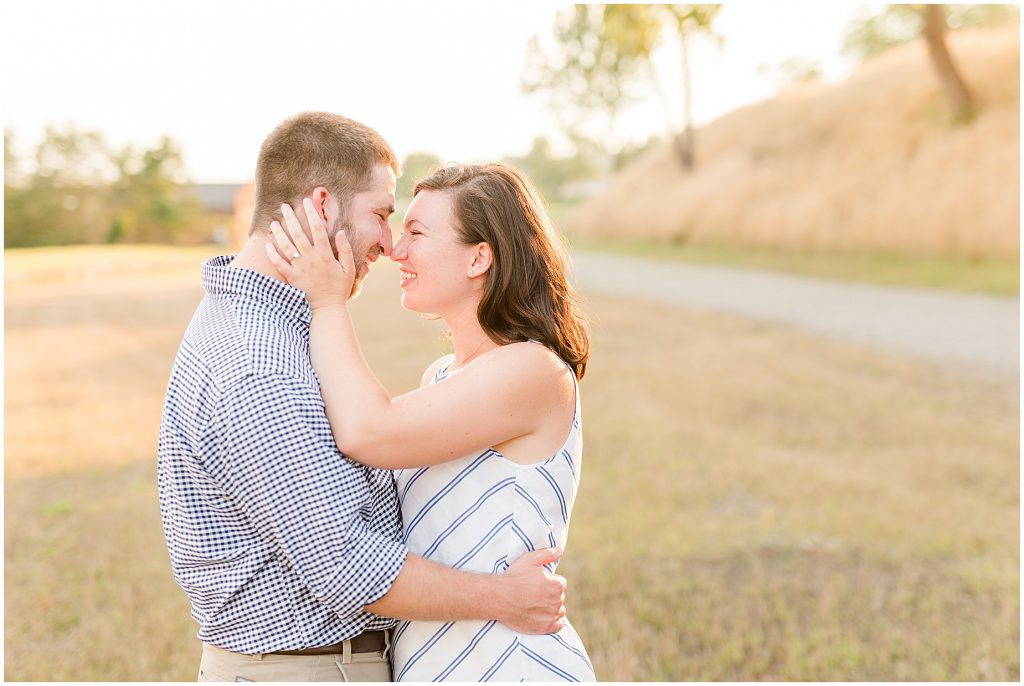 richmond engagement couple on hill near browns island with glowy sun behind