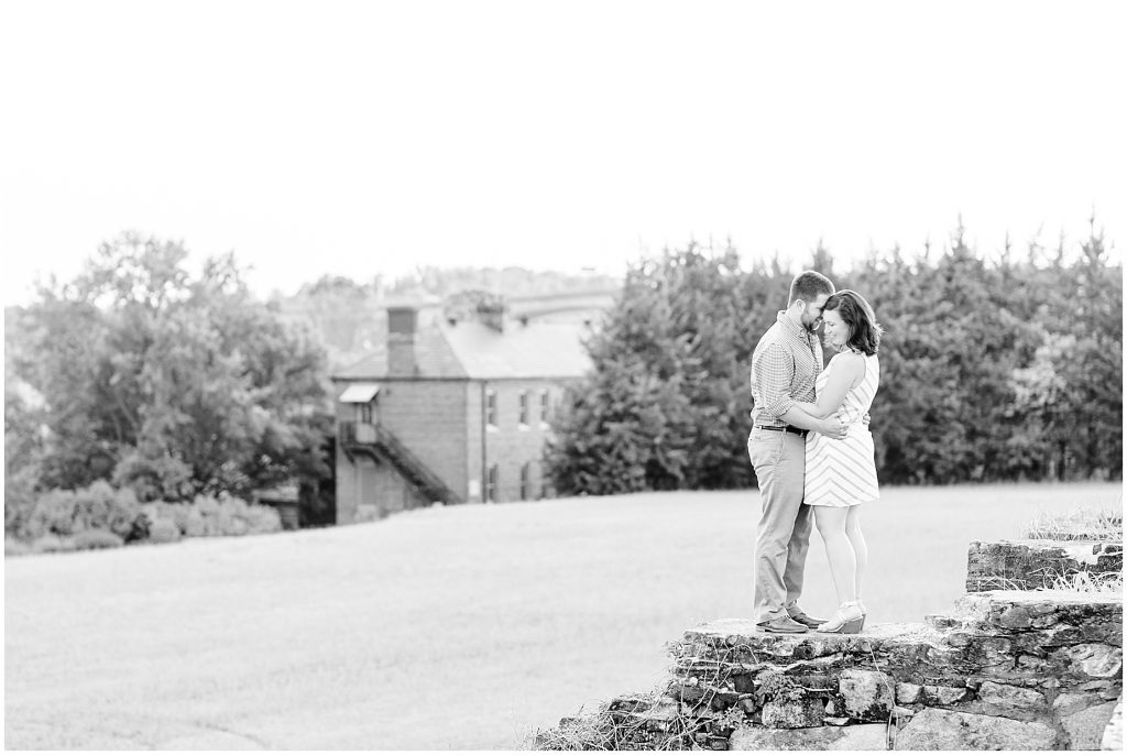 richmond engagement couple on barrier wall overlooking tredegar ironworks