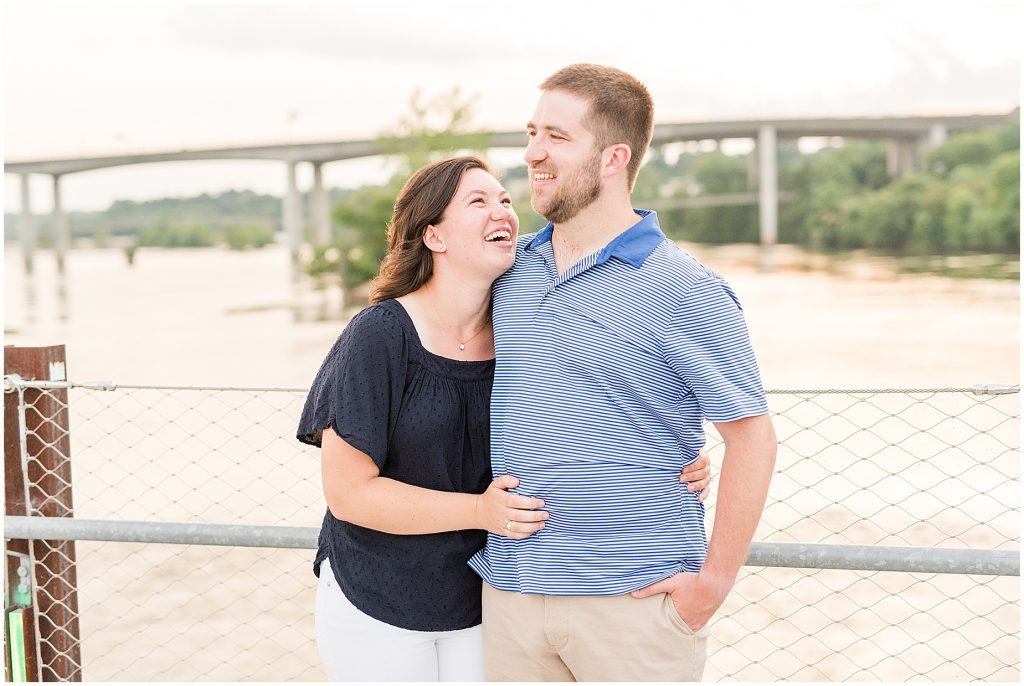 richmond engagement couple laughing on T Pottersfield bridge close to belle isle and browns island