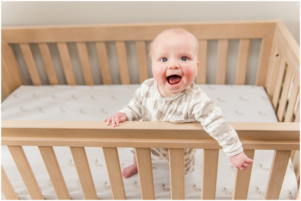 baby in crib in safari themed nursery