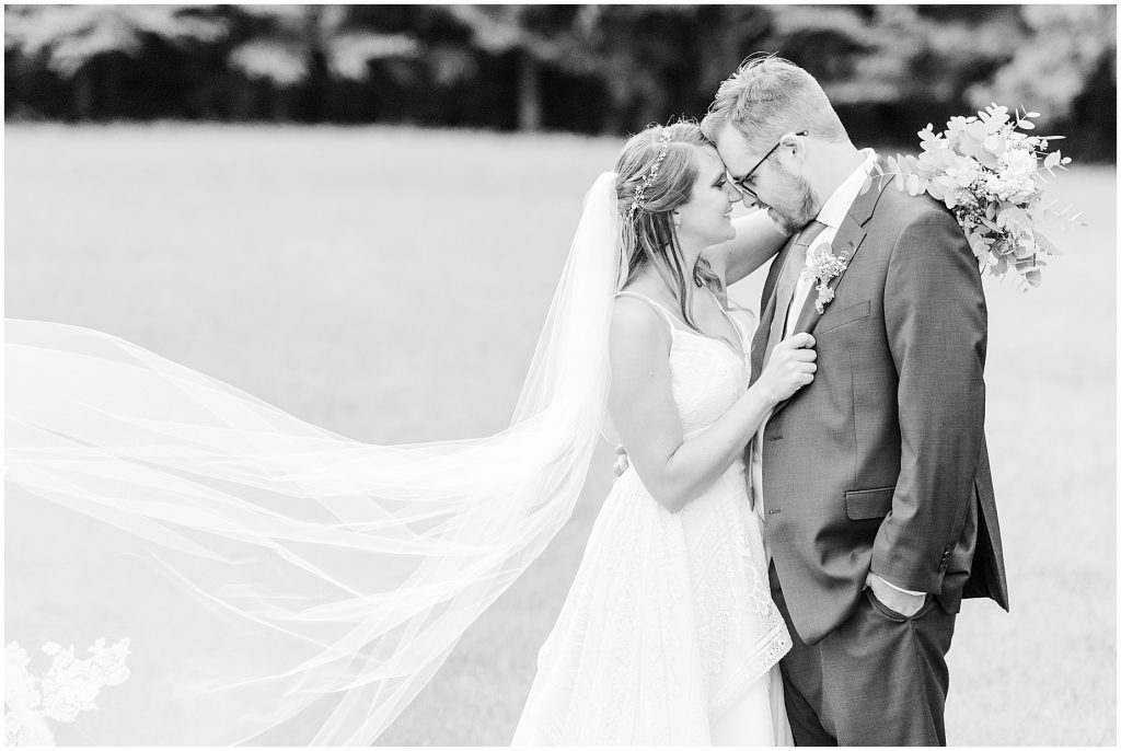 bride and groom in field chanco on the james river richmond virginia wedding photographers