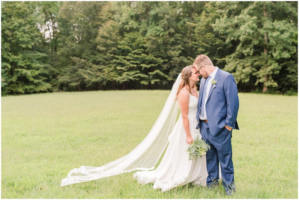 bride and groom in field chanco on the james river richmond virginia wedding photographers