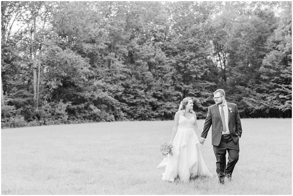 bride and groom in field chanco on the james river richmond virginia wedding photographers