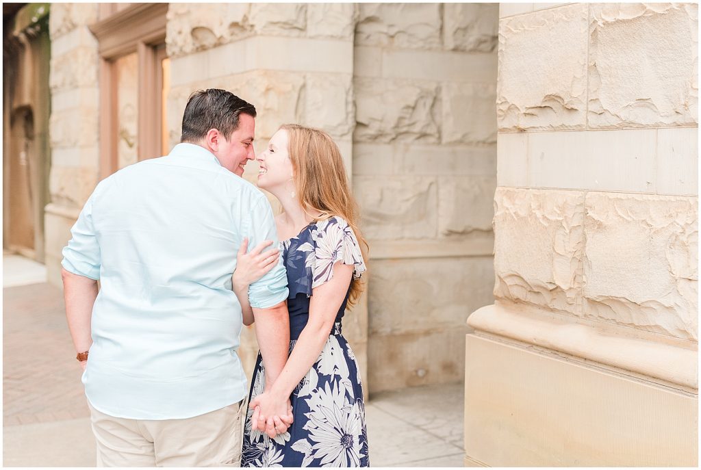 engaged couple standing by main street station in downtown richmond