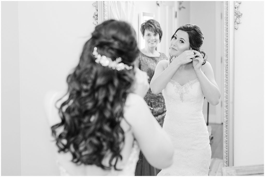 mother helping bride into wedding dress at amber grove bridal suite