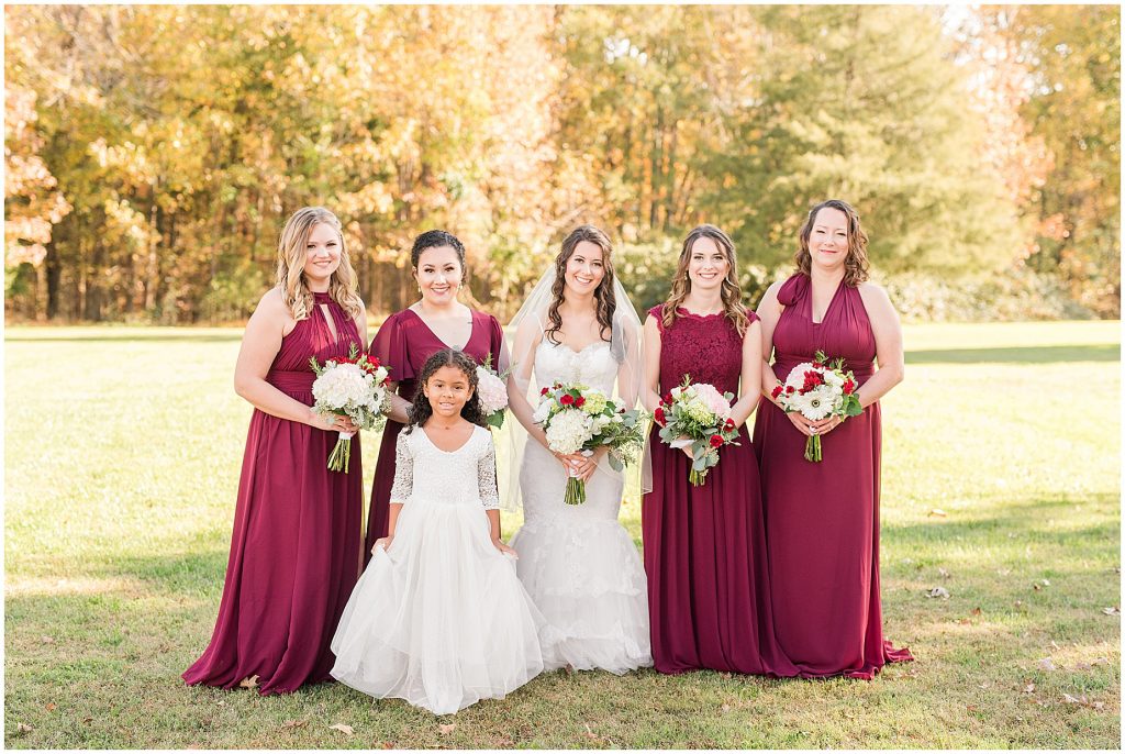 bride and bridesmaids outdoor fall portraits at amber grove virginia wedding venue